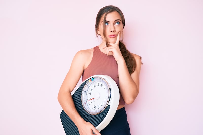 Woman holding scale weight loss
