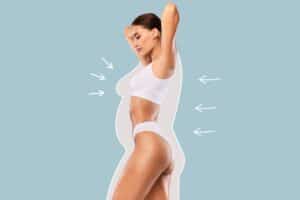 A profile shot of a woman posing in white underwear, showing the results of a mommy makeover